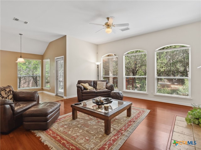 living room featuring hardwood / wood-style flooring, lofted ceiling, and ceiling fan