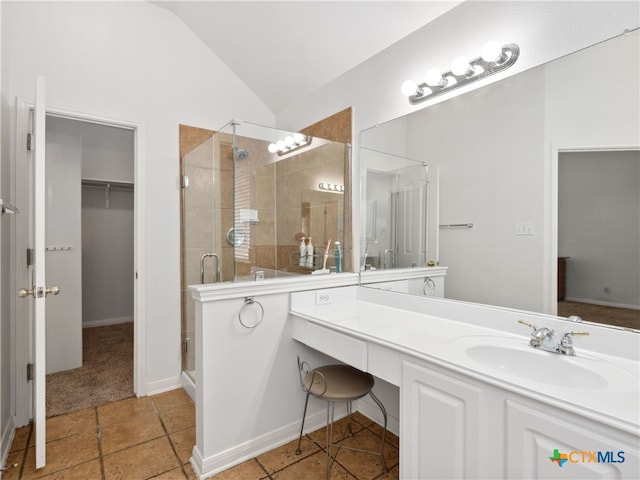 bathroom featuring vanity, lofted ceiling, and a shower with shower door