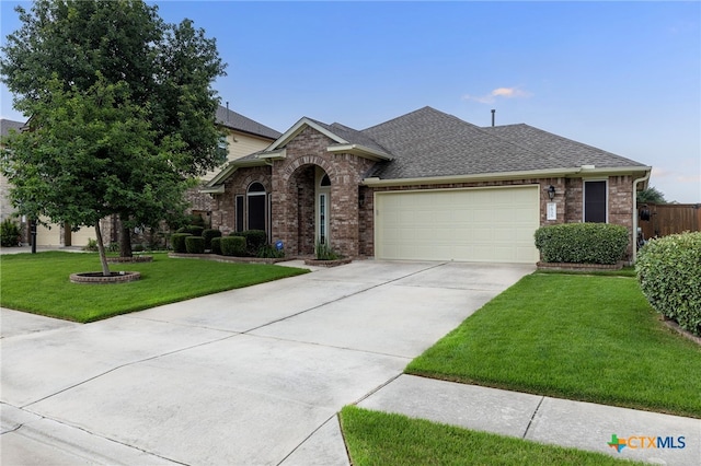 2935 Angelina Dr, Round Rock, TX 78665 - view of front of home featuring brick siding, a garage, driveway, and roof with shingles