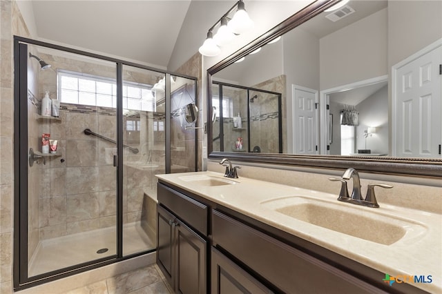2935 Angelina Dr, Round Rock, TX 78665 - full bathroom featuring vaulted ceiling, a stall shower, and double vanity