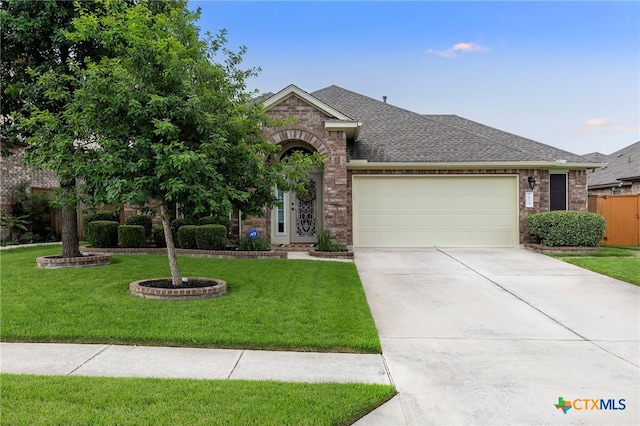2935 Angelina Dr, Round Rock, TX 78665 - view of front of house with roof with shingles, a garage, brick siding, and concrete driveway