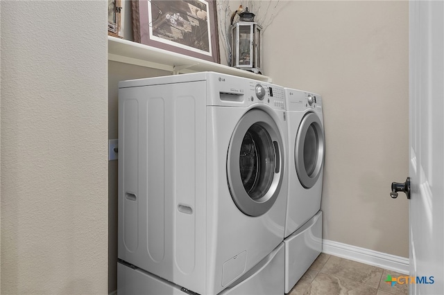 2935 Angelina Dr, Round Rock, TX 78665 - laundry room with washing machine and clothes dryer, baseboards, and light tile patterned floors