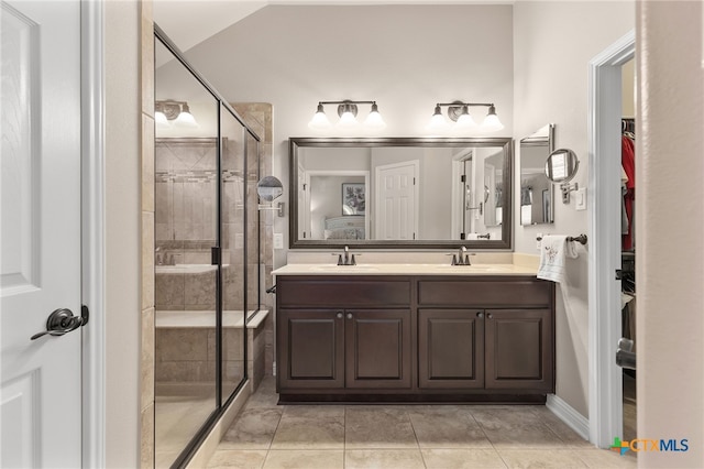 2935 Angelina Dr, Round Rock, TX 78665 - bathroom with a shower stall, tile patterned flooring, double vanity, and a spacious closet