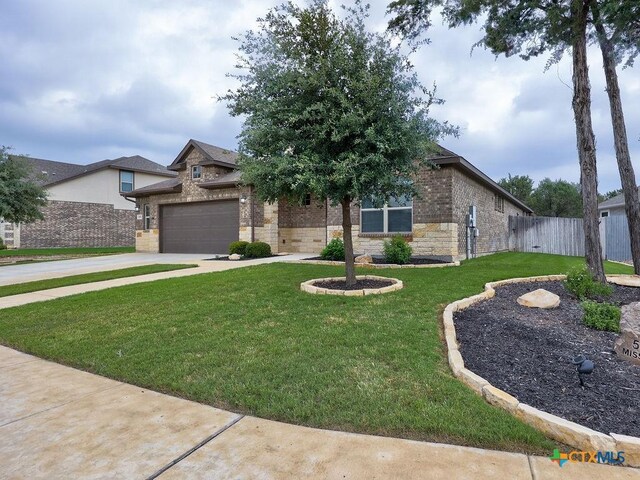 599 Mission Hill Run, New Braunfels, TX 78132 - view of front facade with driveway, an attached garage, brick siding, and stone siding