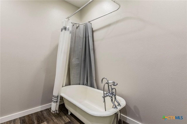 14380 Spotted Horse Ln, Salado, TX 76571 - full bathroom featuring a freestanding tub, baseboards, and wood finished floors