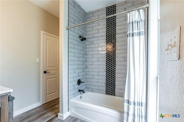 14380 Spotted Horse Ln, Salado, TX 76571 - bathroom with shower / bath combo, wood finished floors, and baseboards