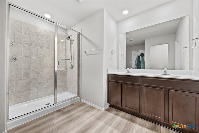 8903 Cantera Ridge Rd, Temple, TX 76502 - bathroom with a stall shower, wood finished floors, and double vanity