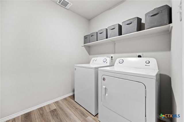 8903 Cantera Ridge Rd, Temple, TX 76502 - laundry room featuring washing machine and clothes dryer and light wood-style flooring