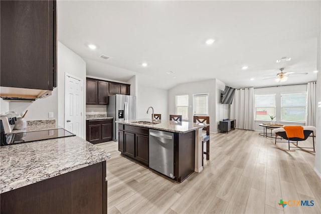 8903 Cantera Ridge Rd, Temple, TX 76502 - kitchen featuring stainless steel appliances, dark brown cabinets, ceiling fan, light wood-style flooring, and a kitchen island with sink