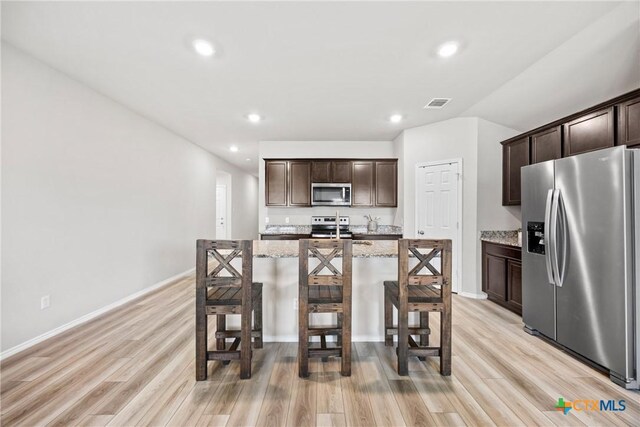 8903 Cantera Ridge Rd, Temple, TX 76502 - kitchen featuring appliances with stainless steel finishes, dark brown cabinetry, light wood finished floors, and recessed lighting