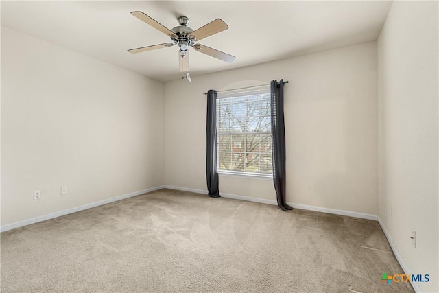 unfurnished room featuring ceiling fan and light colored carpet