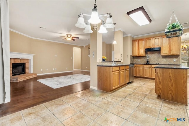 kitchen featuring dishwasher, ventilation hood, ceiling fan with notable chandelier, crown molding, and decorative light fixtures