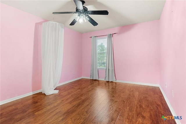 spare room featuring hardwood / wood-style floors and ceiling fan