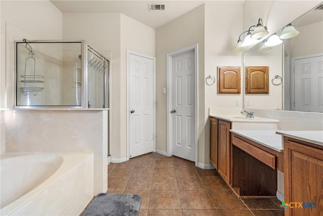 bathroom featuring tile patterned flooring, vanity, and shower with separate bathtub