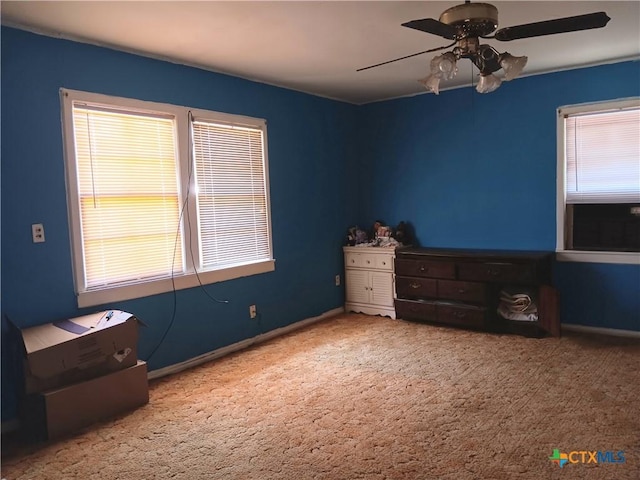 unfurnished bedroom featuring carpet floors and ceiling fan