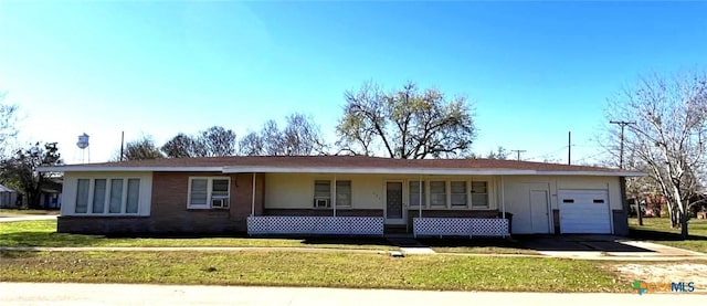 ranch-style house with covered porch, a garage, and a front lawn