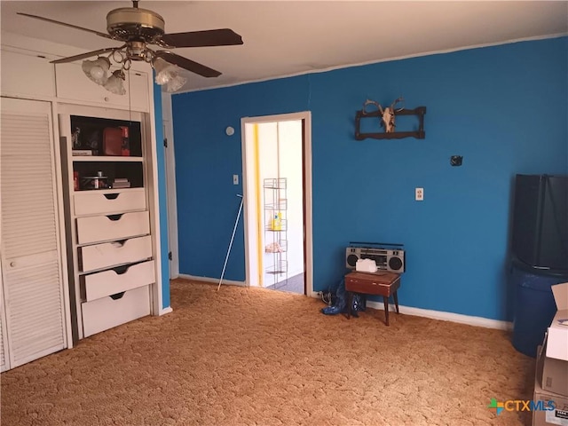 bedroom featuring carpet flooring, ceiling fan, and black fridge