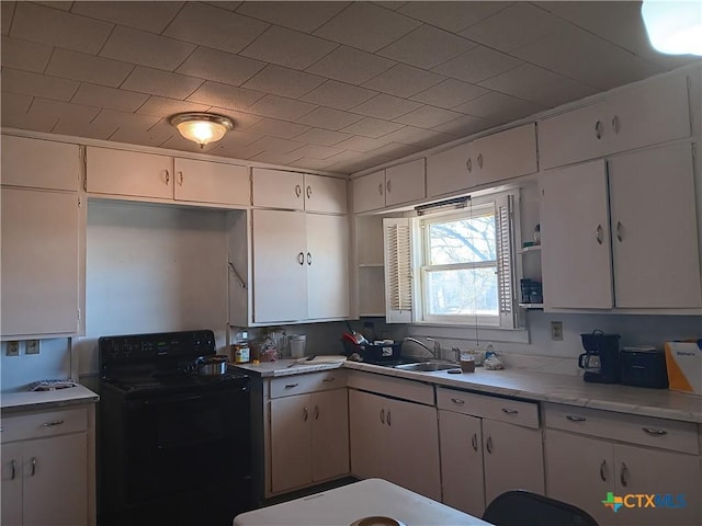 kitchen featuring white cabinetry, sink, and black electric range