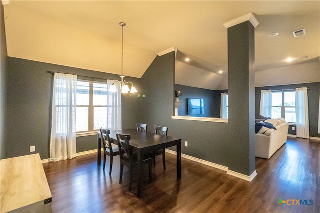 dining room featuring a chandelier, vaulted ceiling, and dark wood-type flooring