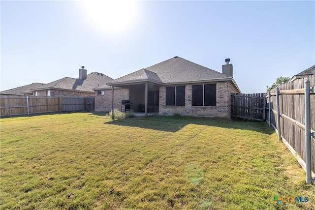 2529 Nolan Creek St, Temple, TX 76504 - back of property featuring brick siding, a chimney, a fenced backyard, and a shingled roof