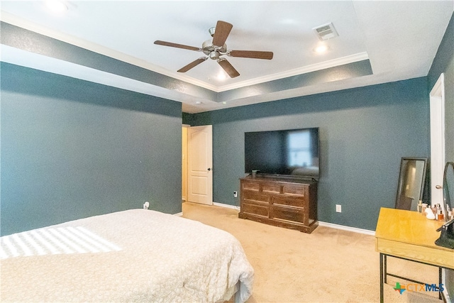 carpeted bedroom featuring a raised ceiling, ceiling fan, and ornamental molding