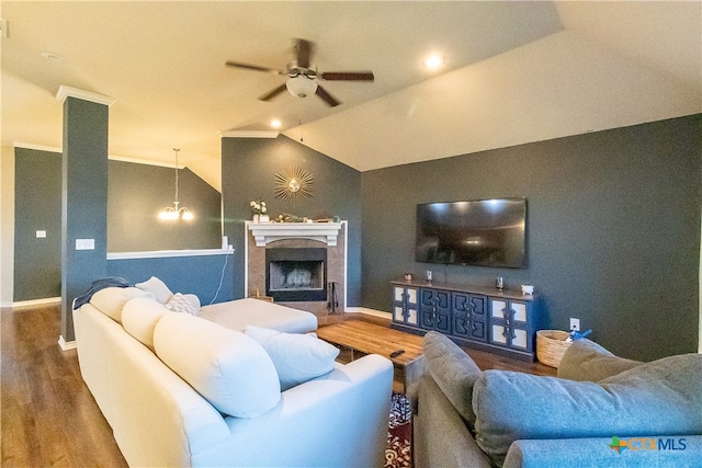 living room featuring hardwood / wood-style flooring, ceiling fan with notable chandelier, and lofted ceiling