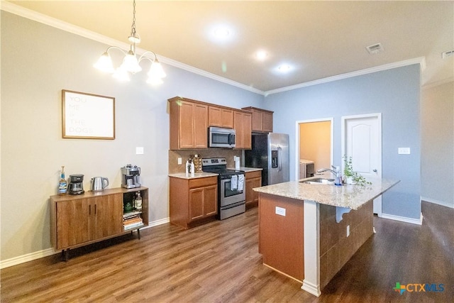 2529 Nolan Creek St, Temple, TX 76504 - kitchen with appliances with stainless steel finishes, crown molding, dark wood finished floors, an island with sink, and a chandelier