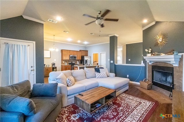 living room with a fireplace, wood-type flooring, lofted ceiling, and ornamental molding