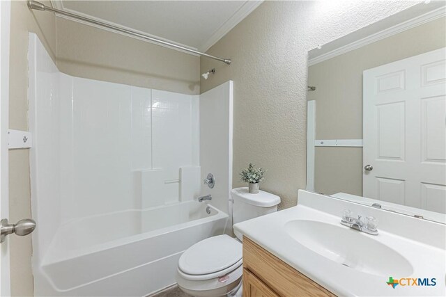 full bath featuring shower / bath combination, crown molding, vanity, toilet, and a textured wall