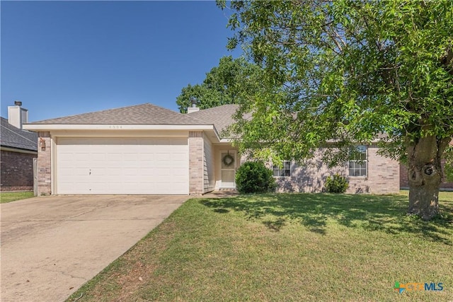view of front of house featuring brick siding, a garage, a front lawn, and driveway