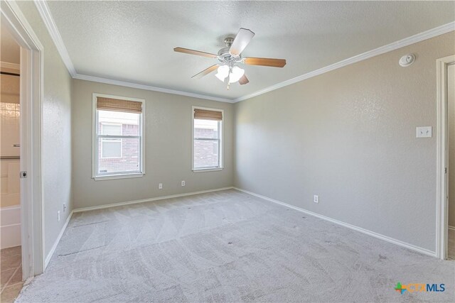 unfurnished room featuring a ceiling fan, a textured ceiling, light colored carpet, and ornamental molding