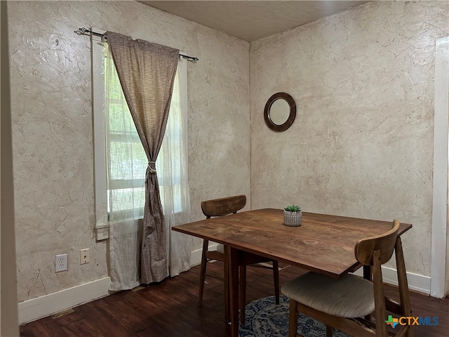 dining space featuring dark hardwood / wood-style floors