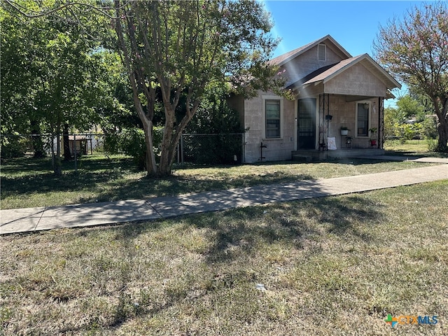 view of front of home with a front yard and covered porch