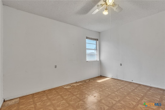 unfurnished room featuring ceiling fan and a textured ceiling