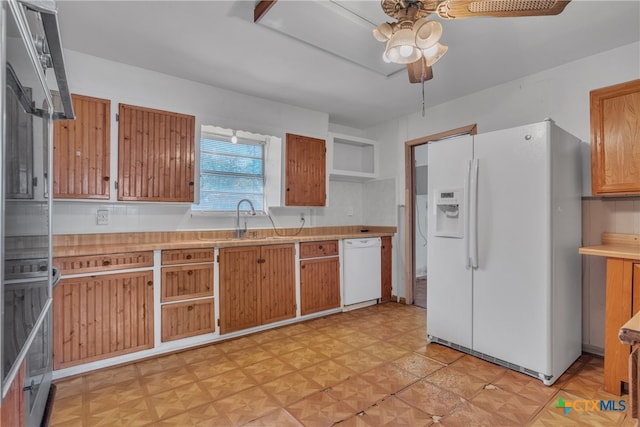 kitchen featuring white appliances, sink, and ceiling fan