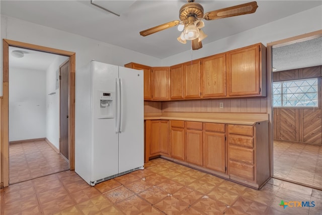 kitchen with white fridge with ice dispenser, a textured ceiling, and ceiling fan