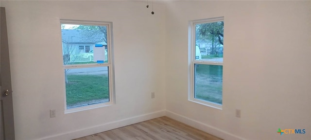 empty room with light hardwood / wood-style flooring