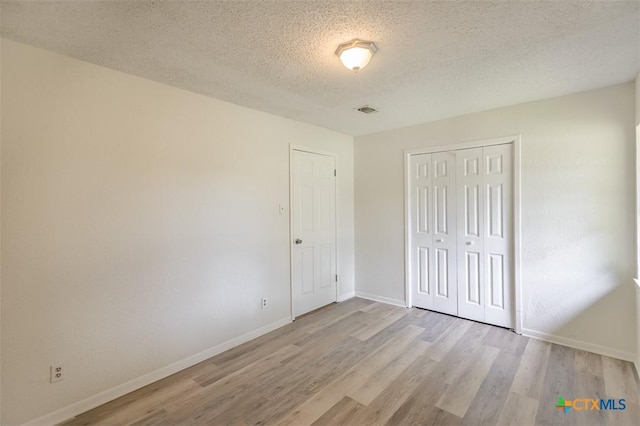 935 Verna Lee Blvd, Harker Heights, TX 76548 - unfurnished bedroom with wood finished floors, a textured ceiling, and a closet