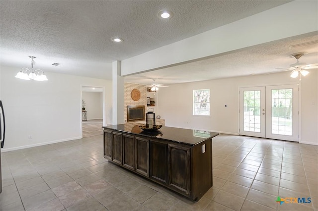 935 Verna Lee Blvd, Harker Heights, TX 76548 - kitchen featuring open floor plan, ceiling fan, light tile patterned floors, a textured ceiling, and dark brown cabinetry