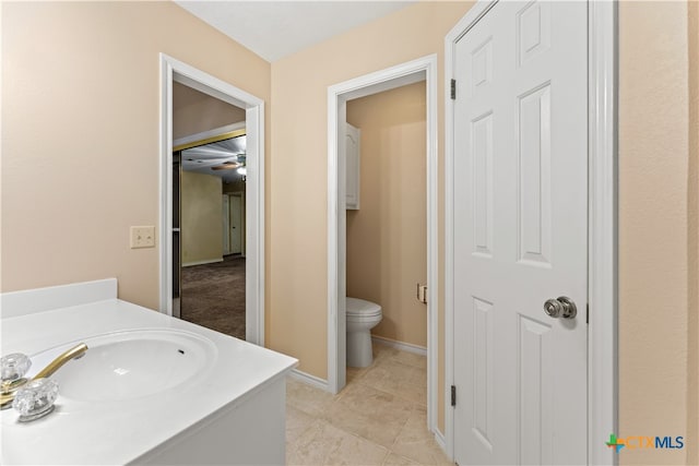 bathroom with tile patterned flooring, vanity, and toilet