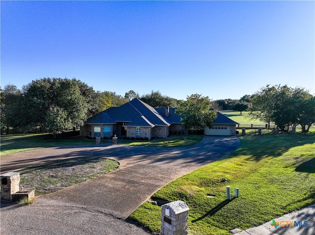 view of front facade with a front yard and a garage