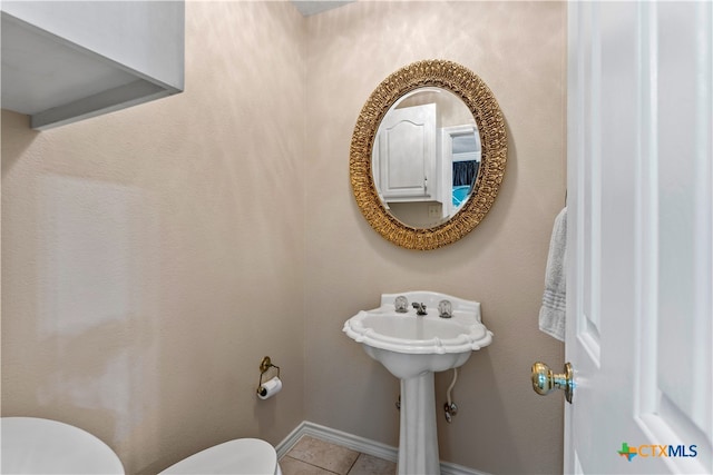 bathroom with tile patterned flooring and toilet