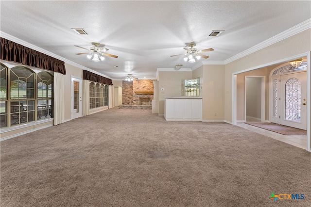 unfurnished living room featuring light carpet, a textured ceiling, ceiling fan, and crown molding