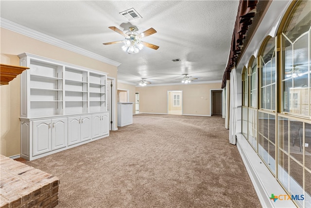 unfurnished living room with crown molding, carpet floors, and a textured ceiling