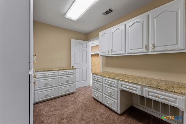 unfurnished office with built in desk and light colored carpet