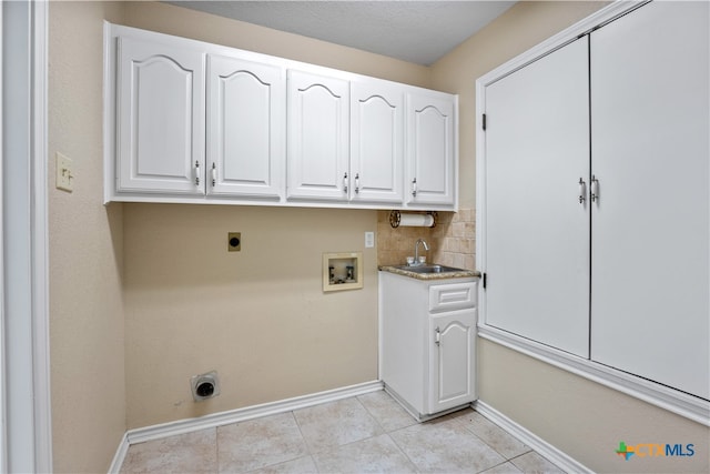 laundry room with sink, cabinets, washer hookup, electric dryer hookup, and light tile patterned floors