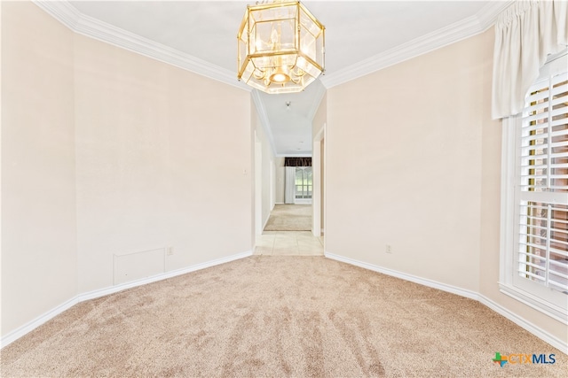 empty room featuring light carpet, crown molding, and a notable chandelier