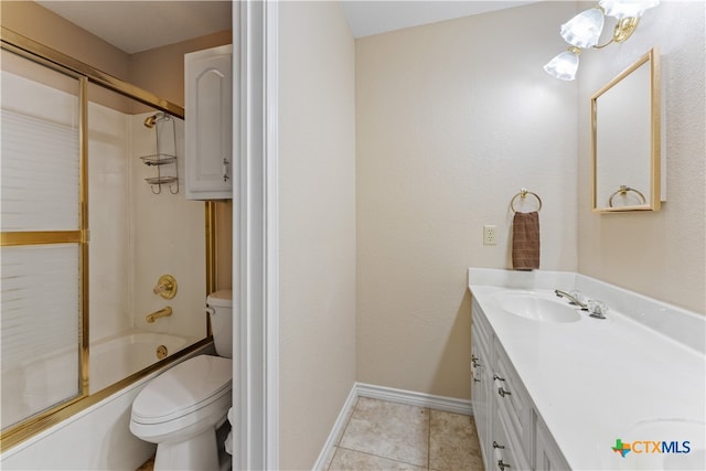 full bathroom featuring shower / bath combination with glass door, vanity, tile patterned floors, and toilet