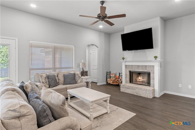 living room featuring baseboards, recessed lighting, a fireplace, dark wood-style floors, and ceiling fan