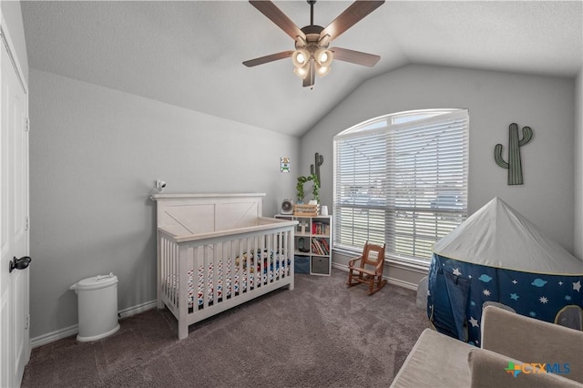 carpeted bedroom featuring ceiling fan, baseboards, vaulted ceiling, and a crib